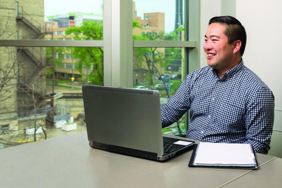 Eliya Ichihashi sitting at the computer in the office
