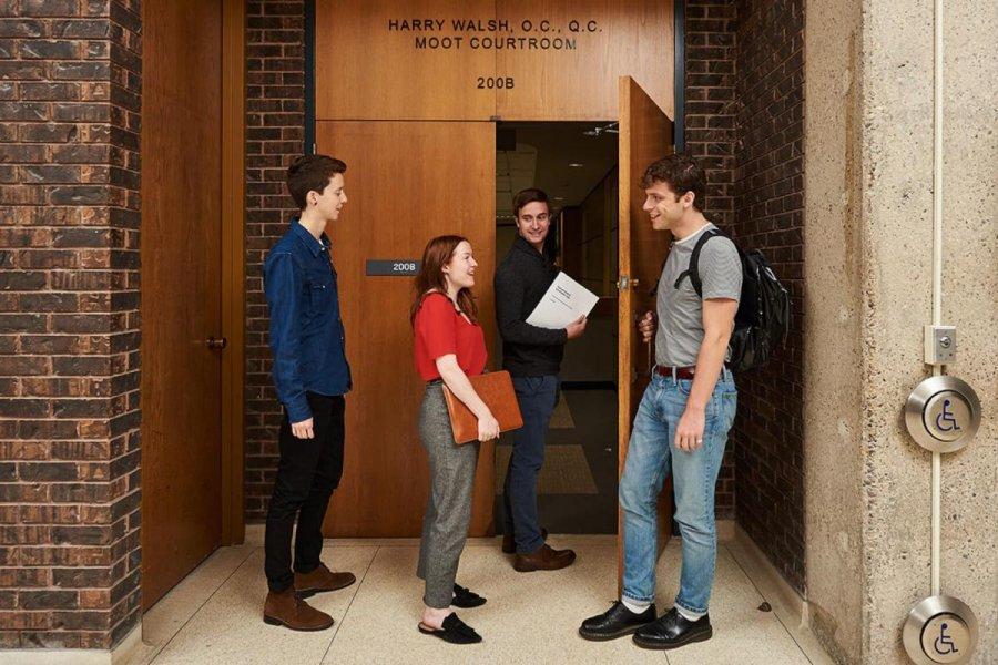 Faculty of Law students standing in a corridor.