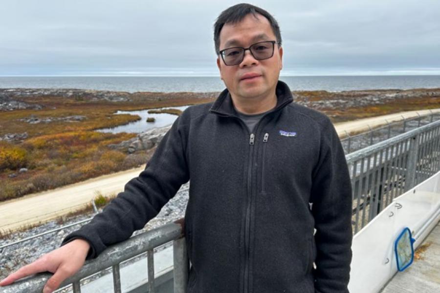 Dr. Feiyue Wang stands outside in Churchill, Manitoba.