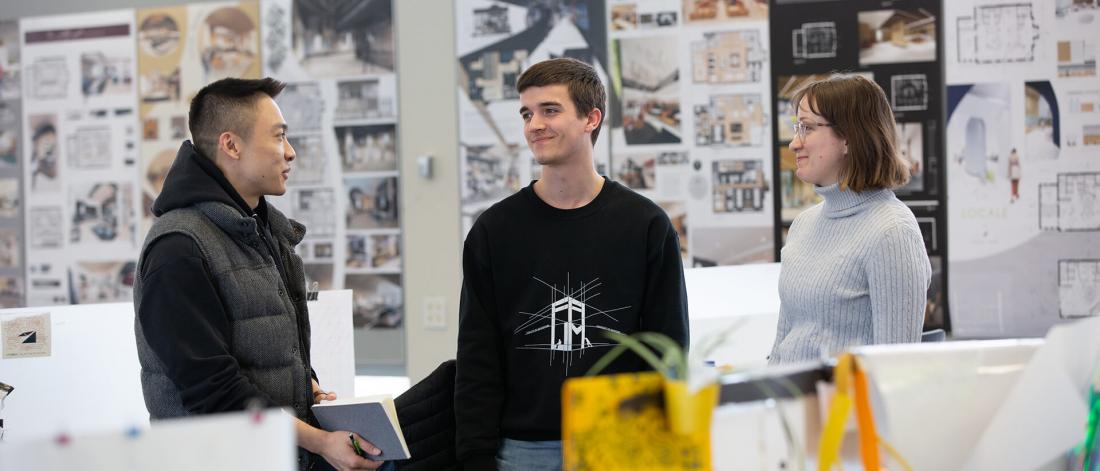 Students standing in an architecture studio.