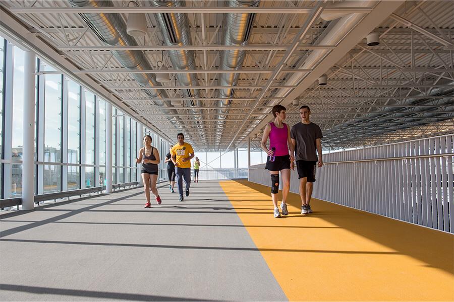Image of various students using the indoor running track.