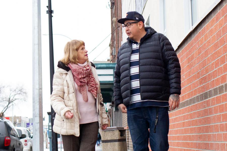 2019 Undergraduate Research award recipient Henry McKay walks down a Winnipeg street with his supervisor.