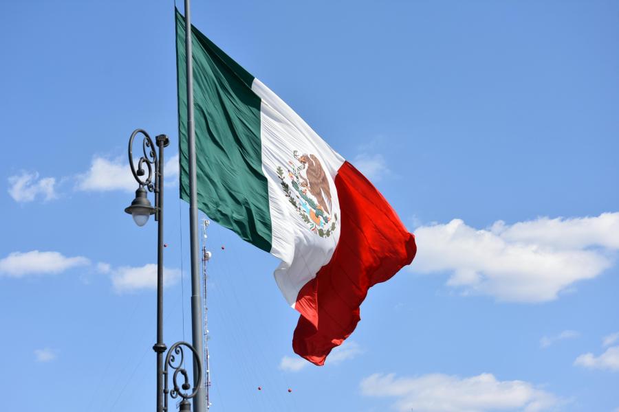 Flag of Mexico swaying against the blue sky