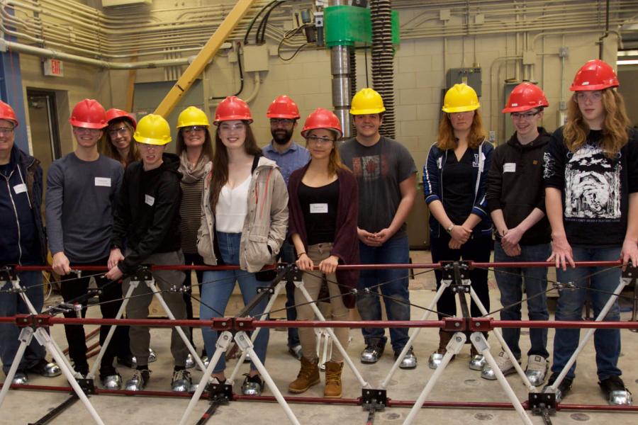 A group of students participating in Science Engineering and Technology day standing together with their instructors.