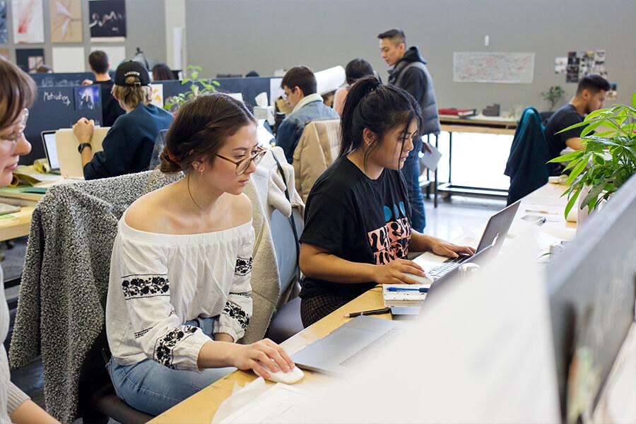 Several students working on computers in a computer lab.