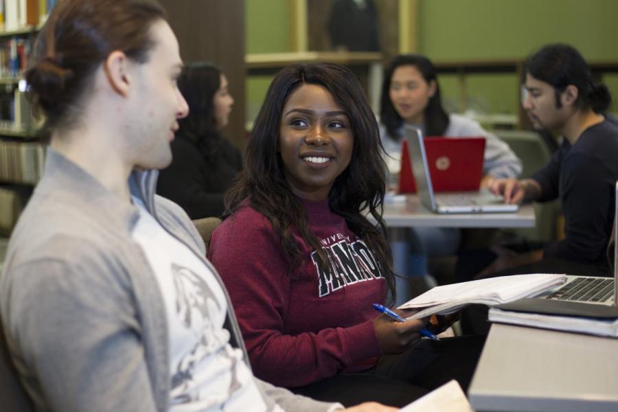 students chatting in the library