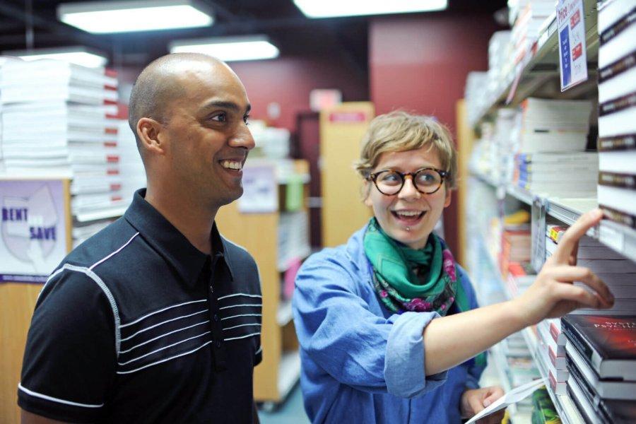 Two students look for books on the shelves at the UMSU University Centre bookstore.