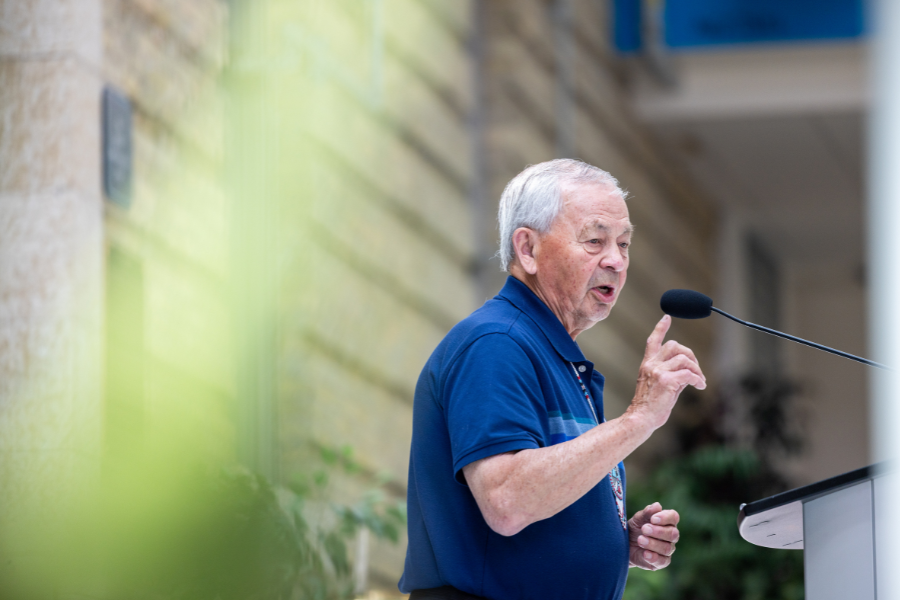 Elder speaks at the podium during the ceremony.
