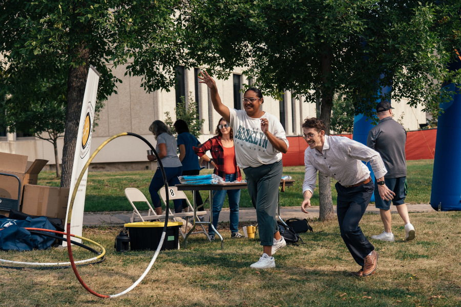 Indigenous Student Orientation participants playing traditional lawn games together outdoors on the grass.