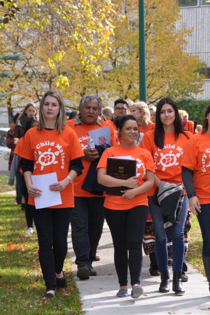 "University of Manitoba nursing department leading a Truth and Reconciliation Walk on campus, with participants wearing orange 'Every Child Matters' shirts.