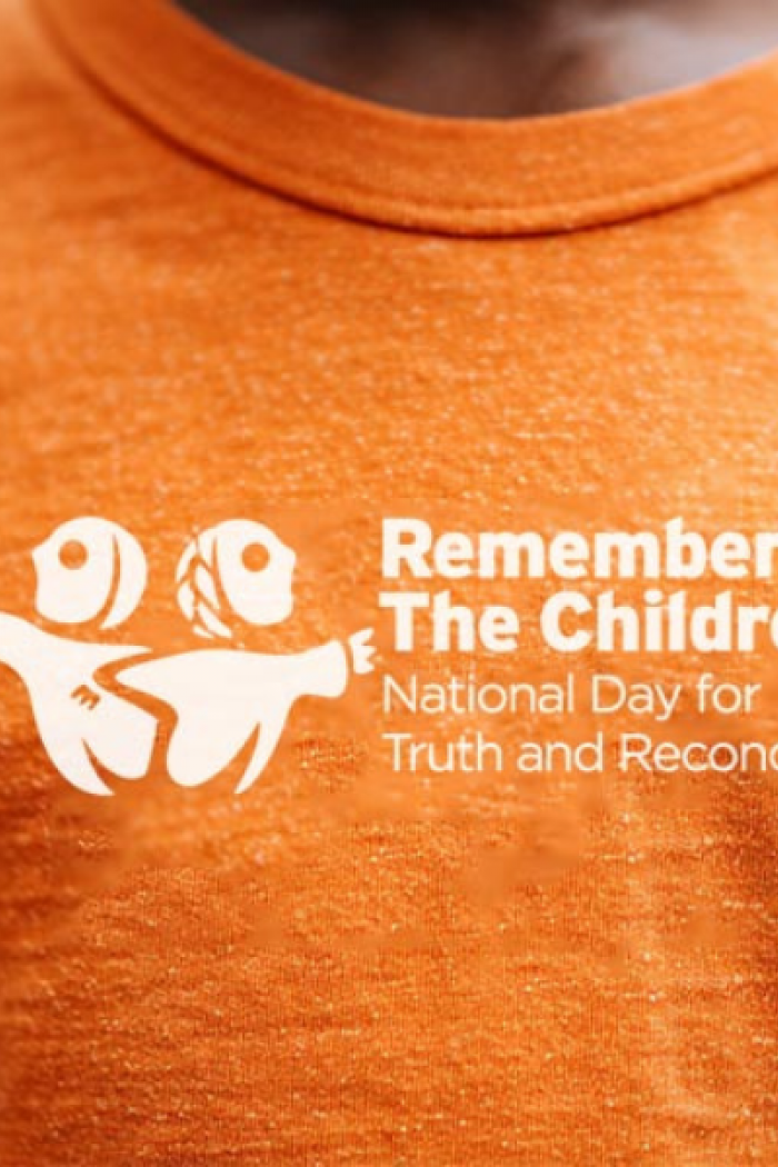 Someone wears an orange shirt.