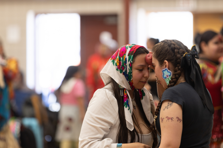 Two participants sharing a game moment at a pow wow